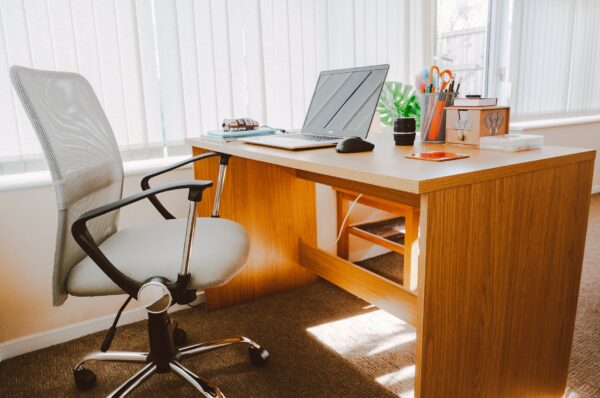 white rolling armchair beside table