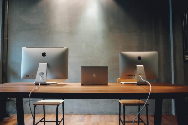 two silver imac on table