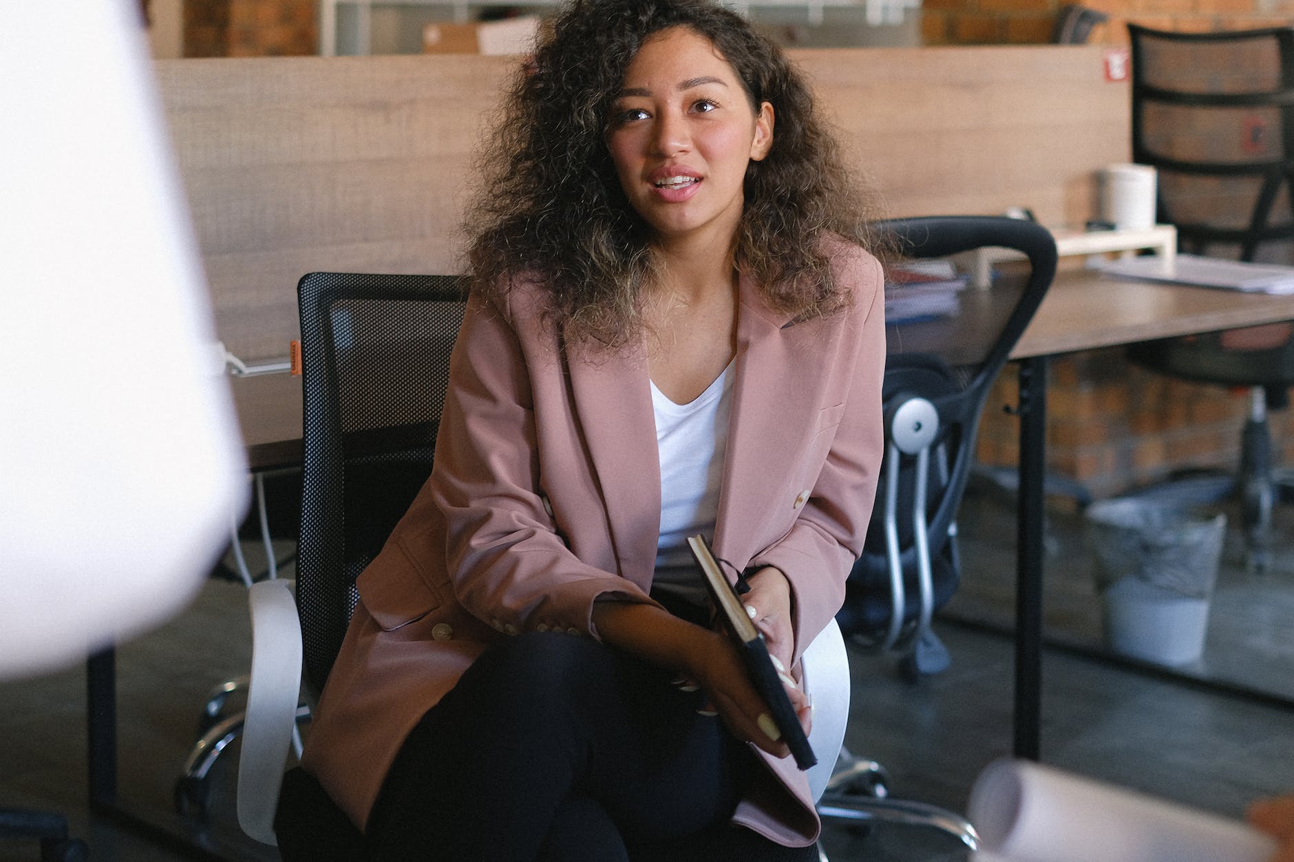 attentive woman listening to report in office